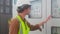 Electrical young man engineer examining maintenance cabinet system electric on rooftop at industrial factory.