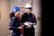 Electrical young woman and man engineer examining maintenance cabinet system electric and looking manual book.