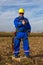 Electrician in blue uniform with yellow helmet in the field