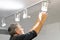 Electrician caucasian man worker installing a ceiling LED spotlight