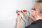 Electrician checks a socket outlet with a voltage detector