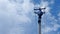 The electrician climbs onto the power line post