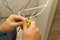 Electrician connecting the cables of the television antenna during the renovation of the house. master assembling