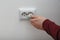 Electrician inserting plug into power socket on white background,