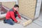 Electrician installing heating electrical cable on concrete floor