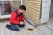 Electrician installing heating electrical cable on concrete floor. Man measure resistance of cable