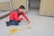 Electrician installing heating electrical cable on concrete floor. Man read instruction