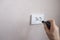 An electrician installs an electrical outlet on the wall. Apartment and house renovation
