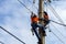 Electrician lineman repairman worker at climbing
