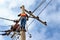 Electrician lineman repairman worker at climbing