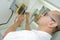 Electrician measuring voltage socket in new building closeup