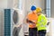 An Electrician Men Checking Air Conditioning Unit