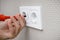 Electrician mounting electric sockets at home. Professional installation