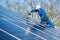 Electrician mounting solar panel on roof of modern house