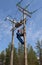 Electrician perform maintenance on the transmission towers recloser