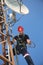 Electrician in red helmet working on 5G antenna system