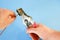 An electrician removes insulation from a copper wire. Working with the tool. Stripper work close-up