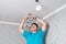 Electrician removes old, inefficient halogen lamps from the ceiling