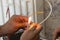 Electrician repairing an electrical installation, using a lighter, close-up