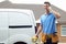 Electrician Standing Next To Van Talking On Mobile Phone