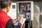 An electrician takes control readings of electricity meters