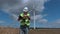 Electrician on the walkie-talkie near wind turbines