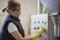 Electrician woman in factory looking panel