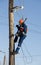 Electrician working at height with wires