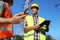 Electricians near high voltage towers, focus on hand with portable radio station