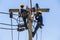 Electricians resting while working on electricity pole
