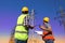 Electricians in uniforms near high voltage towers