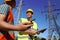 Electricians in uniforms near high voltage towers