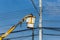 Electricians Wiring Cable repair services,worker in crane truck bucket fixes high voltage power transmission line,setting up the