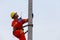 Electricians work on high-voltage electricity poles