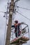 Electricians work on inspection and replacement of lighting poles.