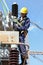 Electricians working on high voltage power lines