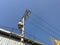 Electricity, electric supply pole against blue sky.