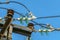 Electricity garlands of insulators with electric wires on a top steel mast