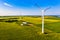 Electricity generation concept. Wind turbines on farmland, aerial landscape