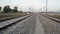 Electricity Indian railway track view with Cement block sleepers. Long rail line view with pebbles