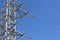 Electricity metal pole silhouette in blue sky, high voltage energy transmission equipment of steel