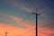 Electricity poles silhouette in sunset background