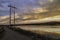 Electricity Poles at Sunrise with Colorado mountains and lake background