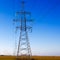 Electricity pylon against blue cloudy sky. Vintage