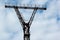 Electricity pylon against cloudy sky background