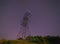 Electricity pylon against night sky