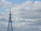 Electricity pylon, electric transmission tower, against the blue sky. Energy tower