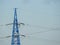 Electricity pylon, electric transmission tower, against the blue sky. Energy tower