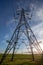 Electricity pylons close up looking up perspective with blue sky