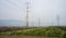 Electricity pylons and lines over arable land